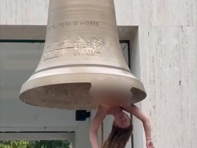 La artista Florentina Holzinger cuelga boca abajo dentro de una enorme campana totalmente desnuda