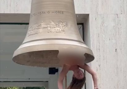 La artista Florentina Holzinger cuelga boca abajo dentro de una enorme campana totalmente desnuda
